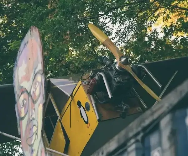 Full size metal airplane hanging outside