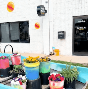 Exterior Front Door at Junkyard with flowers in buckets