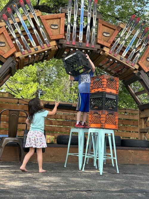 Two children playing under the ski bridge at Junkyard