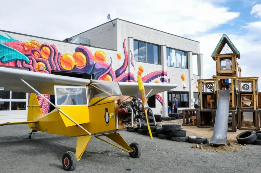 Junkyard's outdoor space with yellow airplane